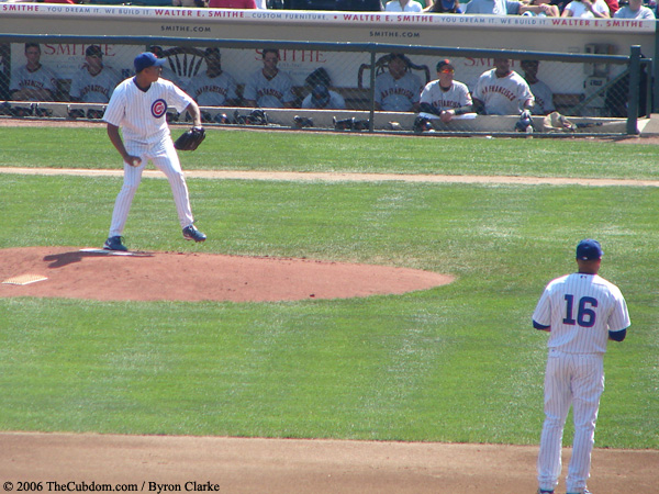 Angel Guzman pitches as Aramis Ramirez looks on