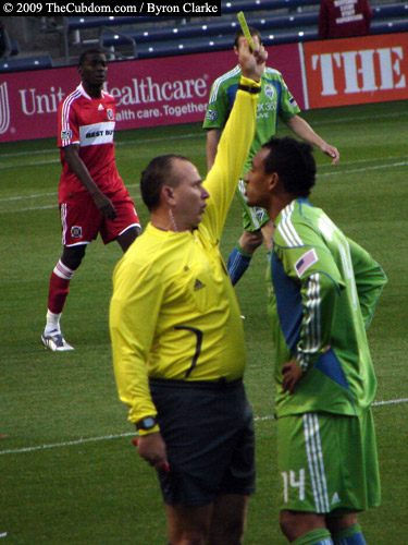 Jasen Anno penalizes Tyrone Marshall with a yellow card booking.